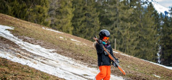 Child,Holding,Ski,And,Walking,On,Grass.,Problem,Of,Global